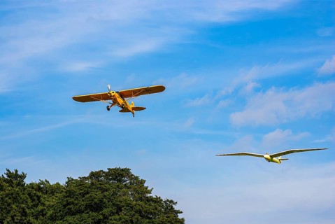 A Piper PA-18 Super Cub tows a glider during an air show at the Rossfeld in Metzingen-Glems,