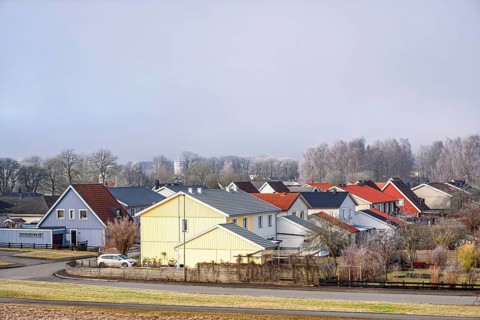 Residential area with detached houses and gardens along streets on a cold winter day, Falköping,