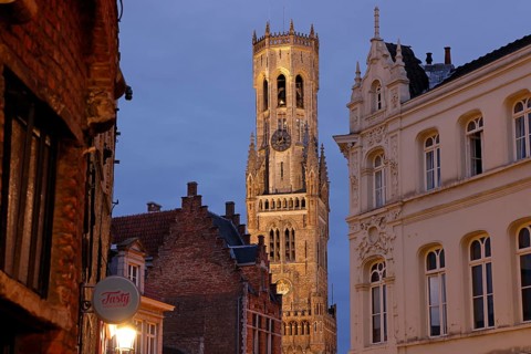 Illuminated Belfry in the historic city centre of Bruges in the evening light, Belfort on the Grote