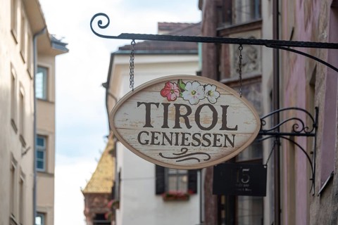 Nostalgic inn sign with the inscription Tyrol genießen, Innsbruck, Tyrol, Austria