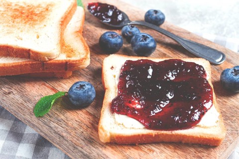 Toast with blueberry jam, on a wooden chopping board, breakfast, homemade, no people