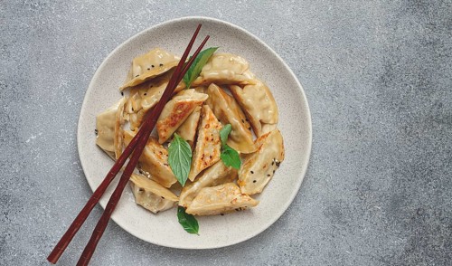 Japanese fried gyoza dumplings, with pork, sesame seeds, green onions