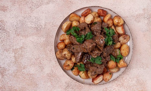 Kuyrdak, roast offal with potatoes and fresh herbs, homemade in Kazakh, no people