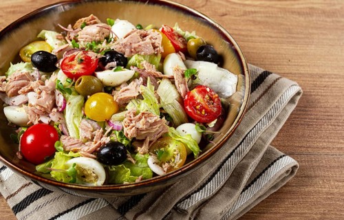 Salad with canned tuna, vegetable salad with quail eggs, lettuce, red onion, cherry tomatoes,