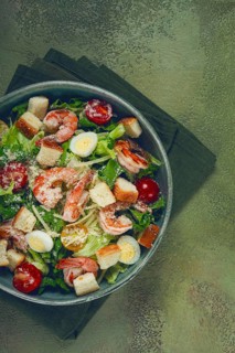Caesar salad, with tiger prawns, shrimp salad, lettuce, quail eggs, cherry tomatoes, parmesan