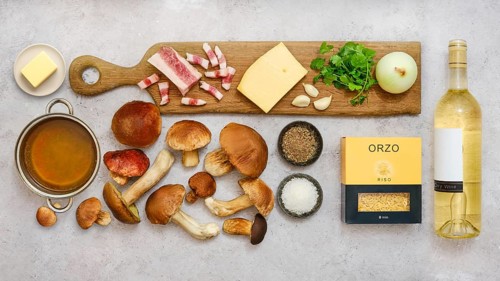 Fresh ingredients for a tasty risoni dish with porcini mushrooms are beautifully arranged on a