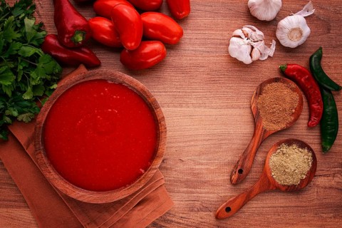 Georgian sauce, Satsebeli sauce, tomato and sweet pepper sauce, with spices, in a wooden bowl,