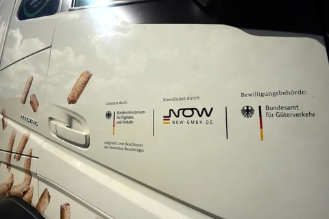 The passenger door of an electric lorry shows which state institutions have paid and approved