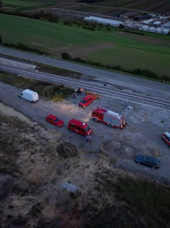 Aerial view of an operation site on railway tracks, several fire engines can be seen, fire drill in