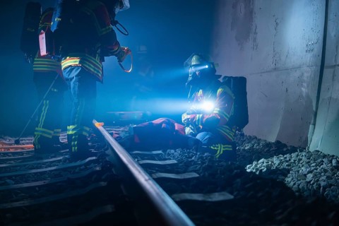 Emergency services on the ground in the tunnel at night, fire brigade exercise in the new tunnel of