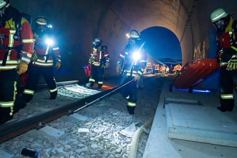 Firefighters in a tunnel at night, strong light illuminates the scene, firefighting exercise in the