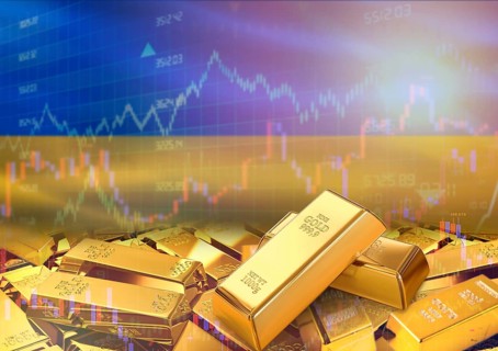 Gold bars on Ukraine flag in background. Gold bars stacked on Ukrainian flag. Concept of Ukraine