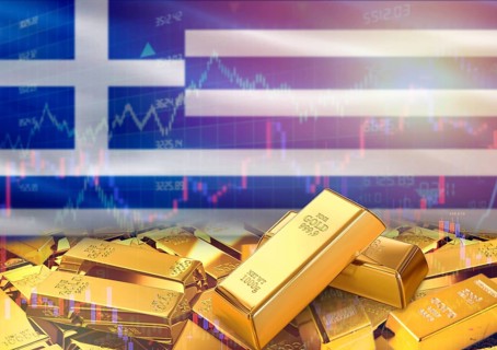 Gold bars on Greece flag in background. Gold bars stacked on Greek flag. Concept of Greece gold