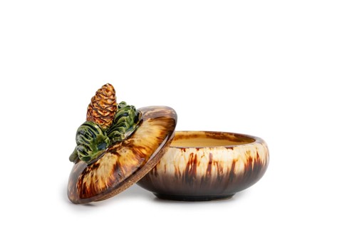 Ceramic jar with pine cones on the lid, white background