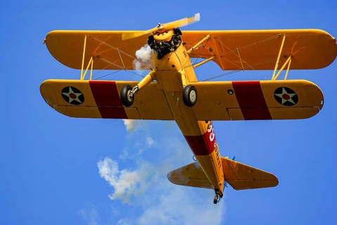 A Boeing-Stearman biplane during a flight demonstration as part of an air show at the Rossfeld in