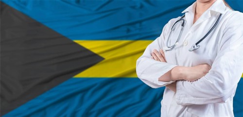 Doctor with crossed arms on Bahamas flag. Bahamas health and care concept. Female doctor on Bahamas