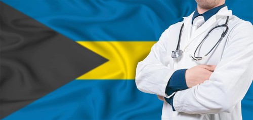 Bahamas healthcare concept. Male doctor on Bahamas flag. Doctor with crossed arms on Bahamas flag