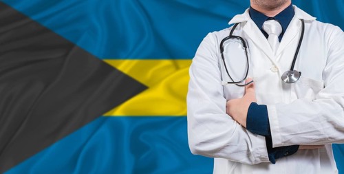 Male doctor with stethoscope on Bahamas flag. Doctor holding stethoscope on Bahamas flag