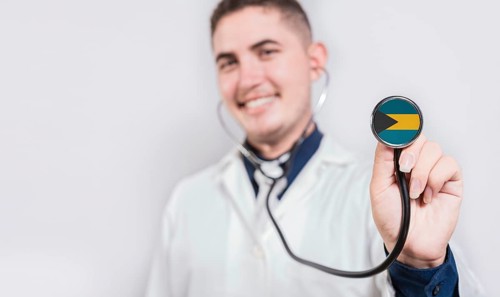 Doctor showing stethoscope with Bahamas flag. Bahamas national healthcare concept