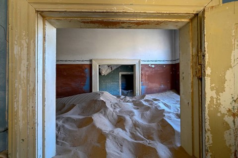 Sand mountains in a former dwelling house, interior photograph, Kolmanskop, restricted diamond