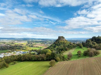 Aerial view of the Hegau volcano and the Hohenkrähen castle ruins, Lake Constance on the horizon,
