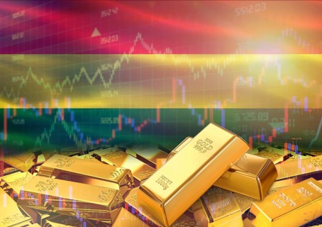 Gold bars on Bolivia flag in background. Gold bars stacked on Bolivian flag. Concept of Bolivia