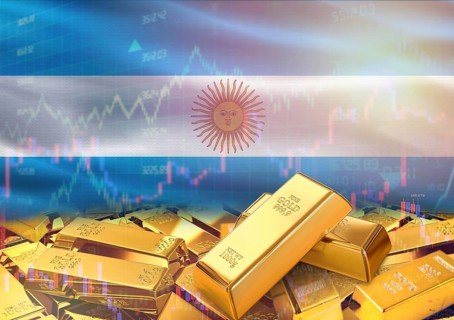 Gold bars on Argentina flag in background. Gold bars stacked on Argentinian flag. Concept of