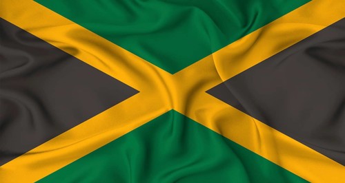 Realistic Jamaica flag waving. Close up of flag of Jamaica with cloth texture