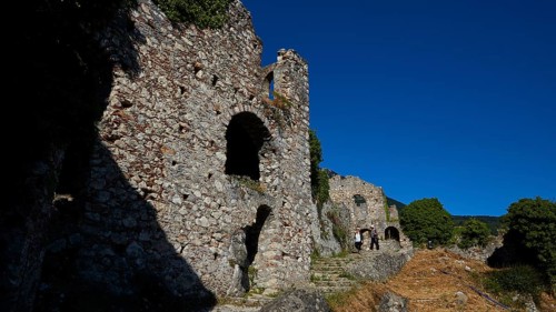 Ancient stone ruins with arches and shadows along a path with a flight of steps, Mystras, Mistra,