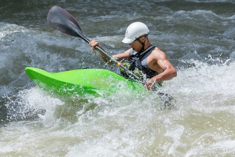 Young man kayaking in river, Costa Rica, Central America