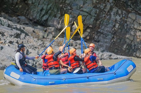 People celebrating white water rafting adventure, Costa Rica, Central America