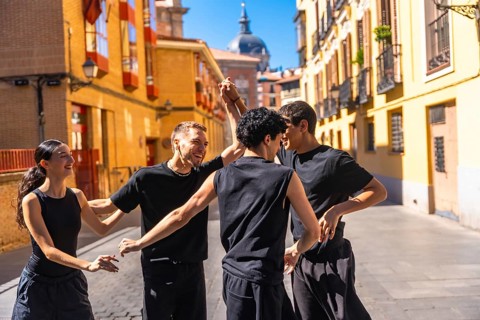 Group of young friends enjoying an urban contemporary dance performance, expressing joy and freedom