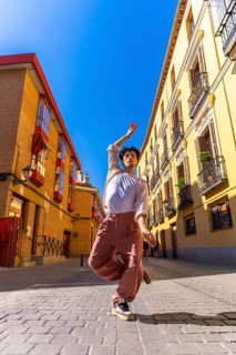 Young man creating art with his body, dancing ballet street style in an urban environment,
