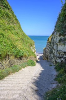 Old concrete access road in the Valleuse d'Etigue, hike from Yport to Etretat along the chalk cliff