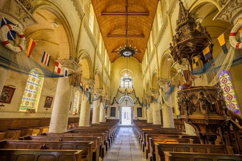 Church of Saint Martin decorated with flags and fishing nets, Yport, Département Seine-Maritime,