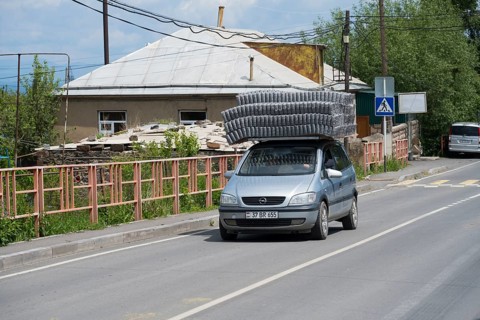 A car carrying goods on its roof, driving along an urban road, Geghhovit, Geghahovit, Verin