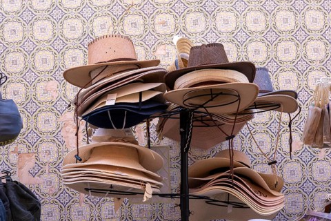 Shop selling various sun hats, old town centre of Tavira, Algarve, Portugal