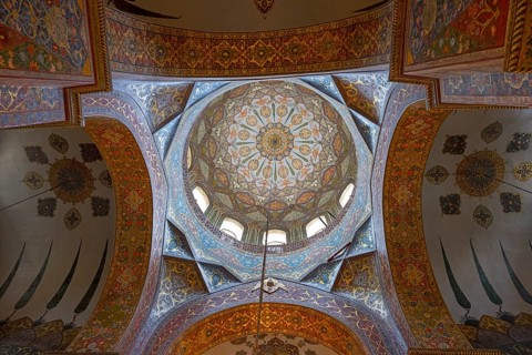 Detailed dome-shaped ceiling painting with elaborate ornaments and warm colours, Inside the