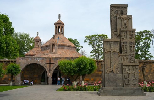 Historic church with characteristic architecture surrounded by manicured gardens and flowers, St