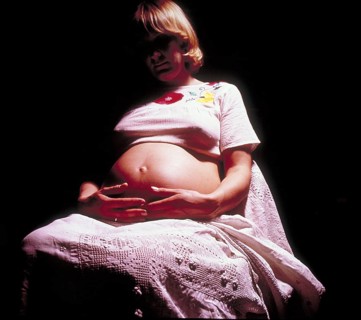Pregnant woman with her hands on her stomach, Bavaria, Germany