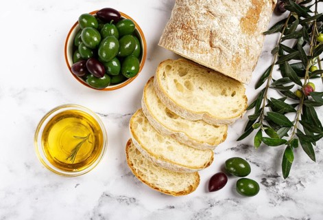 Appetizer, sliced ciabatta bread, with olive oil, green olives, Chalkidiki olives, classic Green