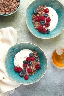 Breakfast, two bowls, yogurt, muesli with berries, and honey, homemade, no people