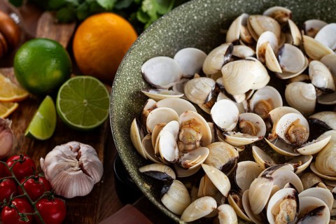 Cooking, vongole clams, in a pan with spices and white wine, top view, no people