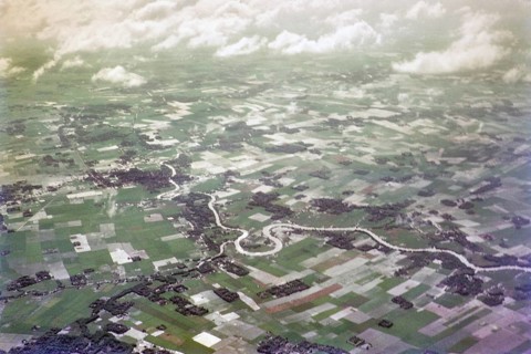 Captioned as 'aerial photo Saigon', meandering river in flat agricultural landscape of paddy