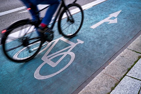 Bicycle, cyclist, rides on cycle path, pictogram, logo, labelling, next to road, movement effect,