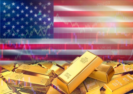 Gold bars on United States flag in background. Gold bars stacked on American flag. Concept of