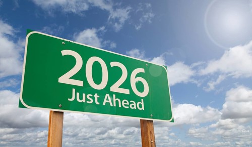 2026 just ahead green road sign over clouds and blue sky