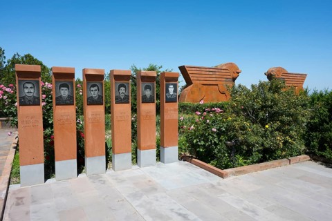 Memorial with portraits of soldiers, surrounded by nature and flowers, Sardarapat Monument, Araks