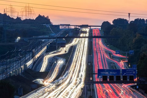 Motorway near Stuttgart with several lanes in the evening with sunset. Heavy traffic with light