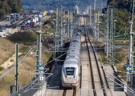 A8 motorway with traffic jam. The new high-speed railway line of Deutsche Bahn AG runs parallel